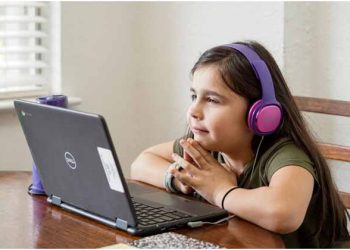a young student focused on an online class at home