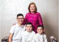 A happy woman with three children after getting an insurance policy